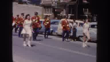 South Dakota USA (1954): Majorettes And Marching Band Walking Down The Street