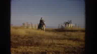 Idaho USA (1955): A Woman And A Second Individual Riding Horses Through