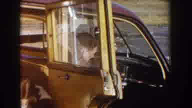 Idaho USA (1955): Couple Sitting On What Seems Like A Old Car From The 50'S She Is