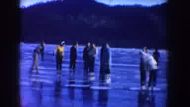 Idaho USA (1955): Group Of People Have Fun On A Frozen Lake In Winter