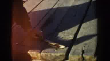 Idaho USA (1955): A Man Smoking, Then Another Man Gutting A Fish On A Dock