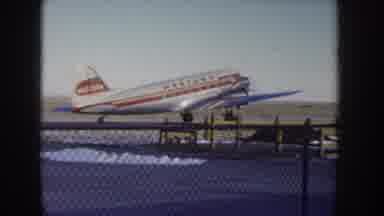 Idaho USA (1955): Red Striped White Plane Slowly Approaching Take Off On Clear Day