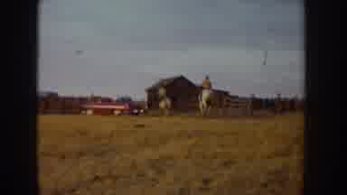 Idaho USA (1955): Two People Riding Horses On A Farm