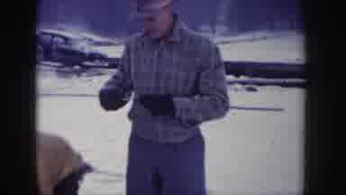 Idaho USA (1955): Three Men Throwing Snow Preparing Ice Fishing Poles On A Winter