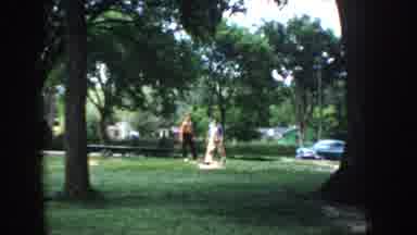 Idaho USA (1955): Two Men Playing Horseshoes In A Park, One Man In Red Shirt