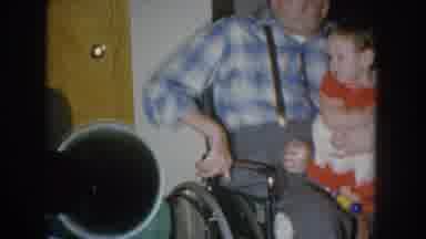 Nebraska USA (1955): Old Man Sitting In A Wheelchair With A Child Sitting On His