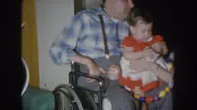 Nebraska USA (1955): Grandmother Holding Her Granddaughter In Her Wheelchair With