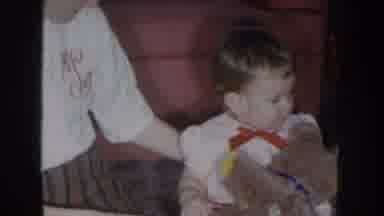 Nebraska USA (1955): Child Plays With Teddy Bear Sitting In The Living Room Of His