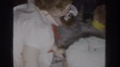 Nebraska USA (1955): Cute Toddler Wearing White Plays With Toy On White Rug