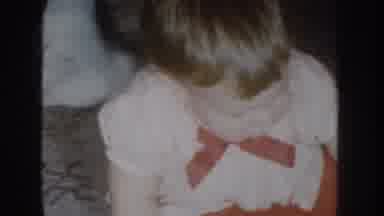 NEBRASKA USA-1955: Baby Girl Playing With Red Toy In White Dress