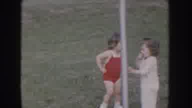 Nebraska USA (1955): Girl Wearing Red Sun Suit Pushes Girl Wearing White Jumpsuit