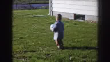 Nebraska USA (1956): Child Playing With His Mother Ball And Running Around Happy