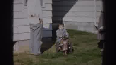 Nebraska USA (1956): Father And Mother Talking To Their Son Who Is Cycling In The