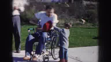 Nebraska USA (1956): Boy Playfully Rolls On Ground And Interacts With His Disabled