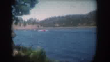South Dakota USA (1956): Big Red Boat Going Through The Lake Leaves Its Unknown