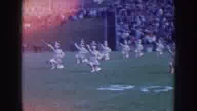 Nebraska USA (1957): Majorettes Ending Performance On Football Field Child Walking