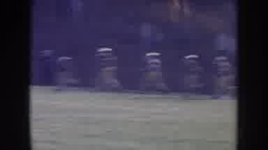 Nebraska USA (1957): Football Team Runs Out Onto The Field With The Crowd Shown