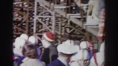 Nebraska USA (1957): Football Team In White Uniforms Running Through Spectator