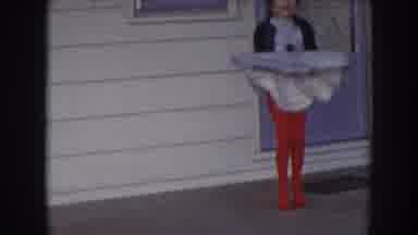 Nebraska USA (1957): Little Girl Dancing On Porch Of A House, Smiling