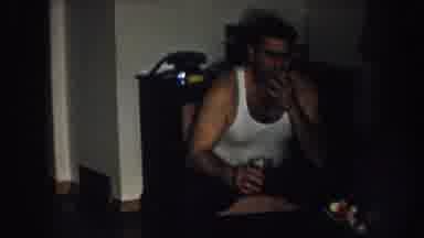 Nebraska USA (1957): Man With Wife Beater Tank Top Smokes Cigarette And Ashes It