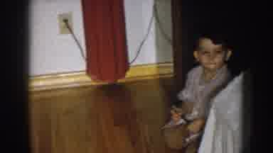 Nebraska USA (1957): A Bored Toddler Boy, Plays By Himself On The Floor In A House