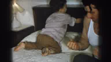 Nebraska USA (1957): The Father And His Son Are Doing Something On The Bed And