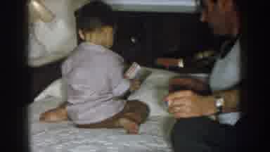 Nebraska USA (1957): Child Playing In The Bedroom On Top Of The Came And With His