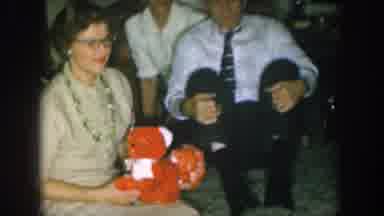 Nebraska USA (1957): Woman Receives Gifts At A Party Including A Red Stuffed Teddy