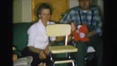 Nebraska USA (1957): A Man And A Woman Showing A Chair Like It Was Very