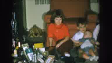 Nebraska USA (1957): Kids Sitting On The Floor In Front Of A Sofa With Christmas