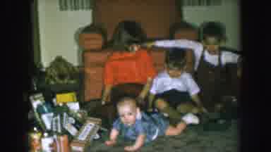 Nebraska USA (1957): Three Children Sitting Around A Baby And One Crawls Up To