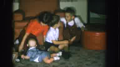 Nebraska USA (1957): Children Play On A Living Room Floor Next To A Christmas Tree
