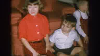Nebraska USA (1957): A Boy Playing In A Child And Two Girls Are Smiling