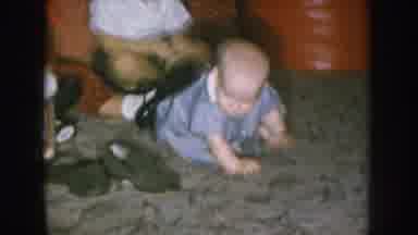 Nebraska USA (1957): A Baby Sitting On The Floor While Two Other Children Play