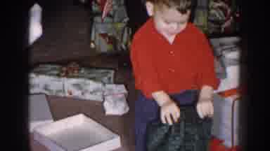 Nebraska USA (1957): Young Boy Willingly Cleans Up After Christmas Morning Gift