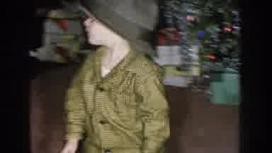 Nebraska USA (1957): Small Boy Child Trying On A Hat While Family Audience Of