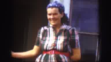 Kansas USA (1958): A Woman Wearing A Dress And A Bandanna Laughing While Looking