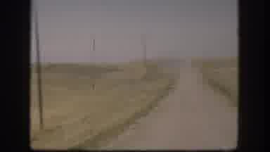 Kansas USA (1958): A Field Empty And A Guy Trying To Reach Something With A Stick
