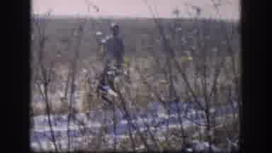KANSAS USA-1958: Man Hunting With Rifle In Snowy Field