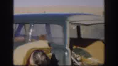 Kansas USA (1958): Man Being Silly With Smoking Friend And Boy With Gun Sitting On