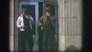 Kansas USA (1958): Two Middle Aged Men Smoking Cigarettes One Man Talking Exiting