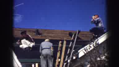 Nebraska USA (1958): Two Men Working On A Roof While The Third Man Takes A Break
