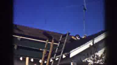 Nebraska USA (1958): Men Installing Roof Top Television Antenna On Clear Sunny Day