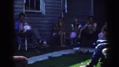 Nebraska USA (1958): Family With Children Sitting Outside Cabin Waiting To Begin