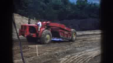 Nebraska USA (1958): A Tractor Working The Land And Another Tractor Mowing The