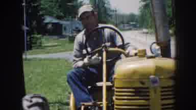 Nebraska USA (1958): Man Stopping His Farm Machine In Front Of His House With His