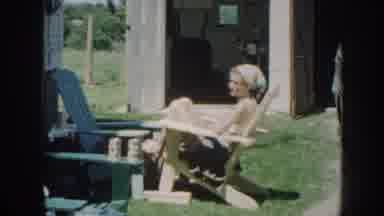 Nebraska USA (1958): Man Sunbathing On The Porch Of His House With His Wife