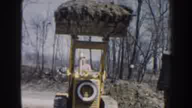 Nebraska USA (1959): Tractor With A Man Driving And Putting Material Elsewhere