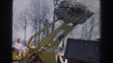 Nebraska USA (1959): Bulldozer Dumping Dirt Into A Truck