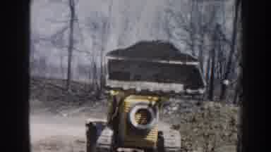 Nebraska USA (1959): Man Drives Tractor Outside In The Daytime Lifting His Crane